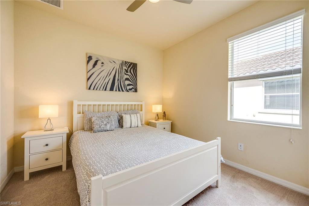 14796 Canton Court Naples, FL 34114 - Photo 13 of 22 a bedroom with a large bed and a window