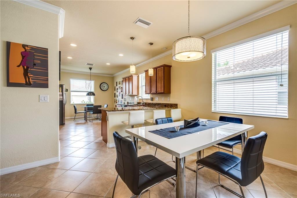14796 Canton Court Naples, FL 34114 - Photo 4 of 22 a view of a dining room with furniture and a chandelier