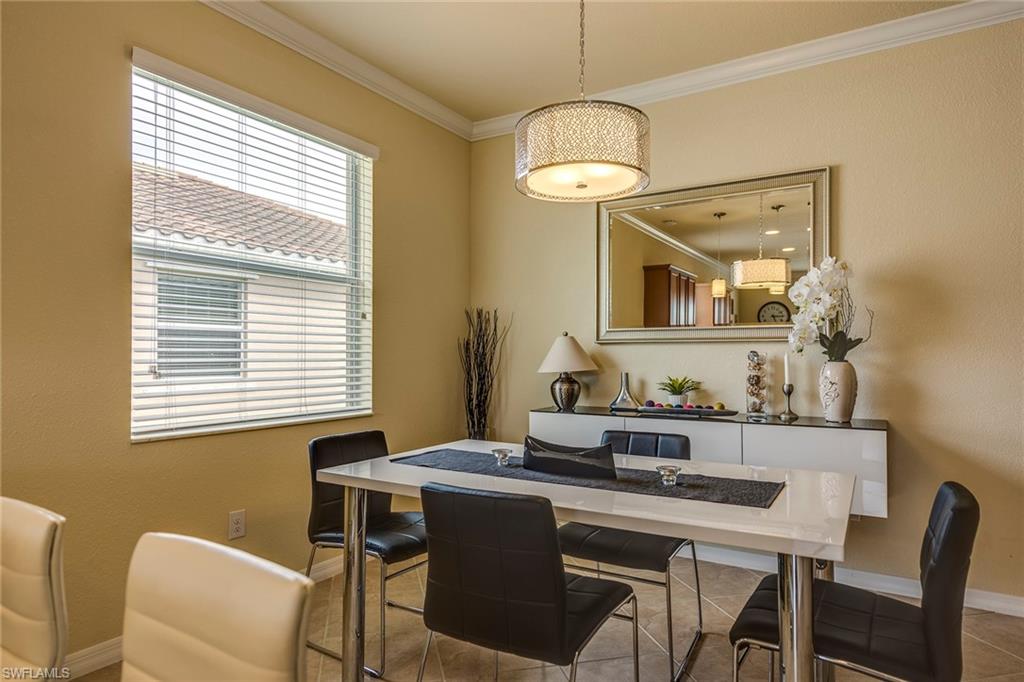 14796 Canton Court Naples, FL 34114 - Photo 9 of 22 a view of a dining room with furniture window and wooden floor