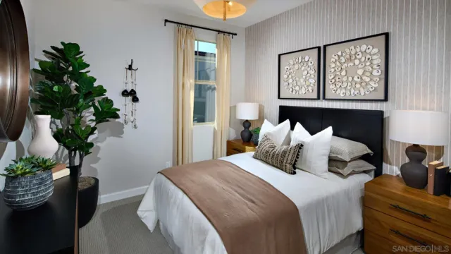 a bedroom with bed and a potted plant