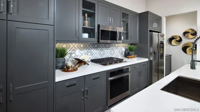 a kitchen with stainless steel appliances a sink stove and refrigerator