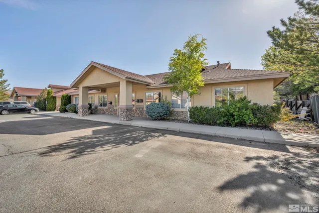 a front view of a house with a yard and a garage