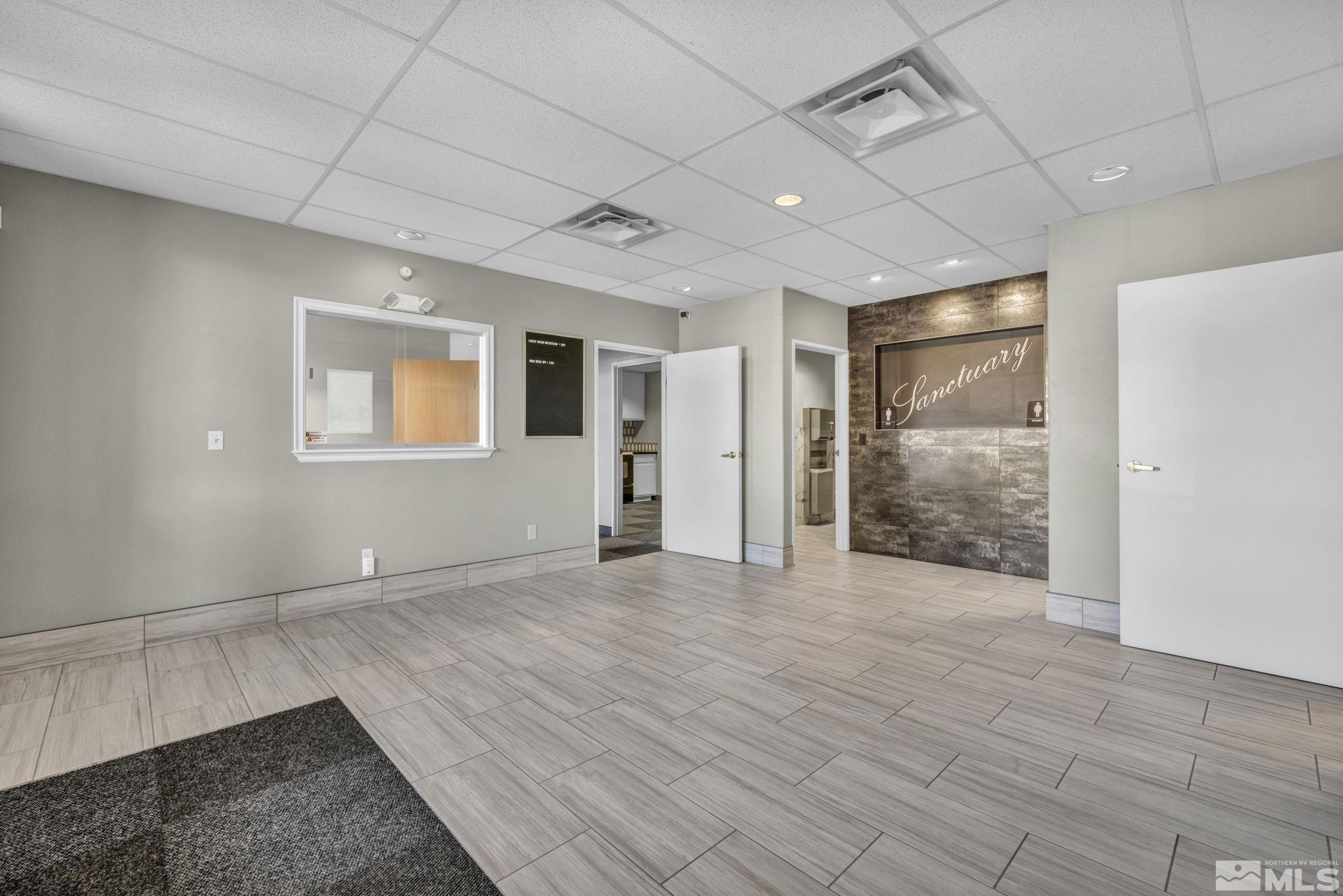 783 Basque Way Carson City, NV 89706 - Photo 11 of 39 a view of an empty room with wooden floor and a window