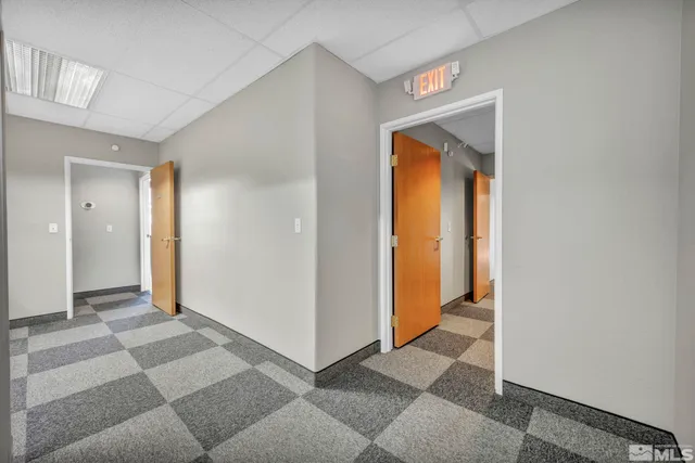 a view of a hallway with wooden shelves