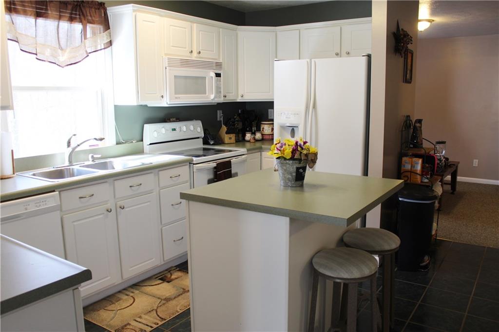 175 Ski-Slope Road Acme, PA 15610 - Photo 9 of 25 Cute center island with seating for a quick breakfast or snack.