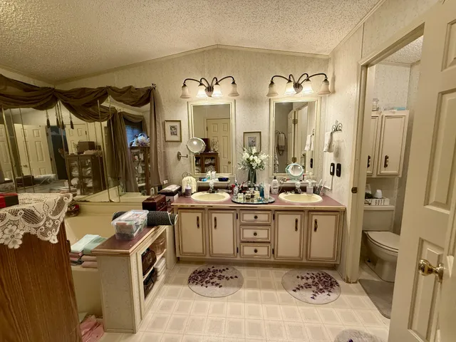 a spacious bathroom with a sink mirror and a bathtub