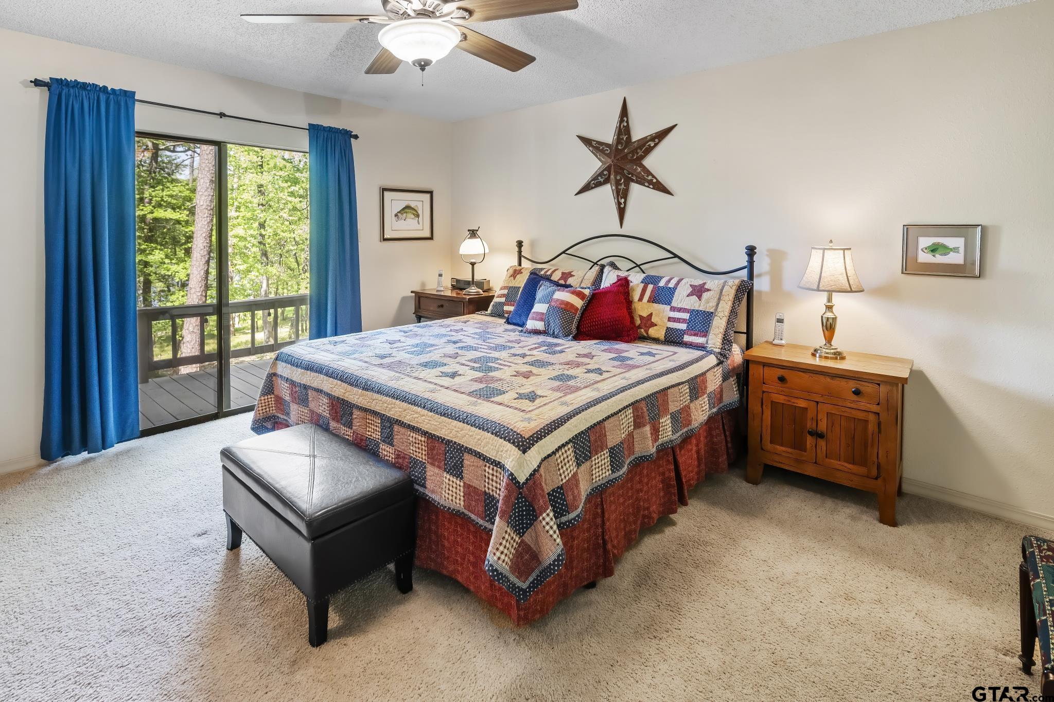 944 Clear Water Trail Holly Lake Ranch, TX 75765 - Photo 12 of 46 a bedroom with a bed table and window