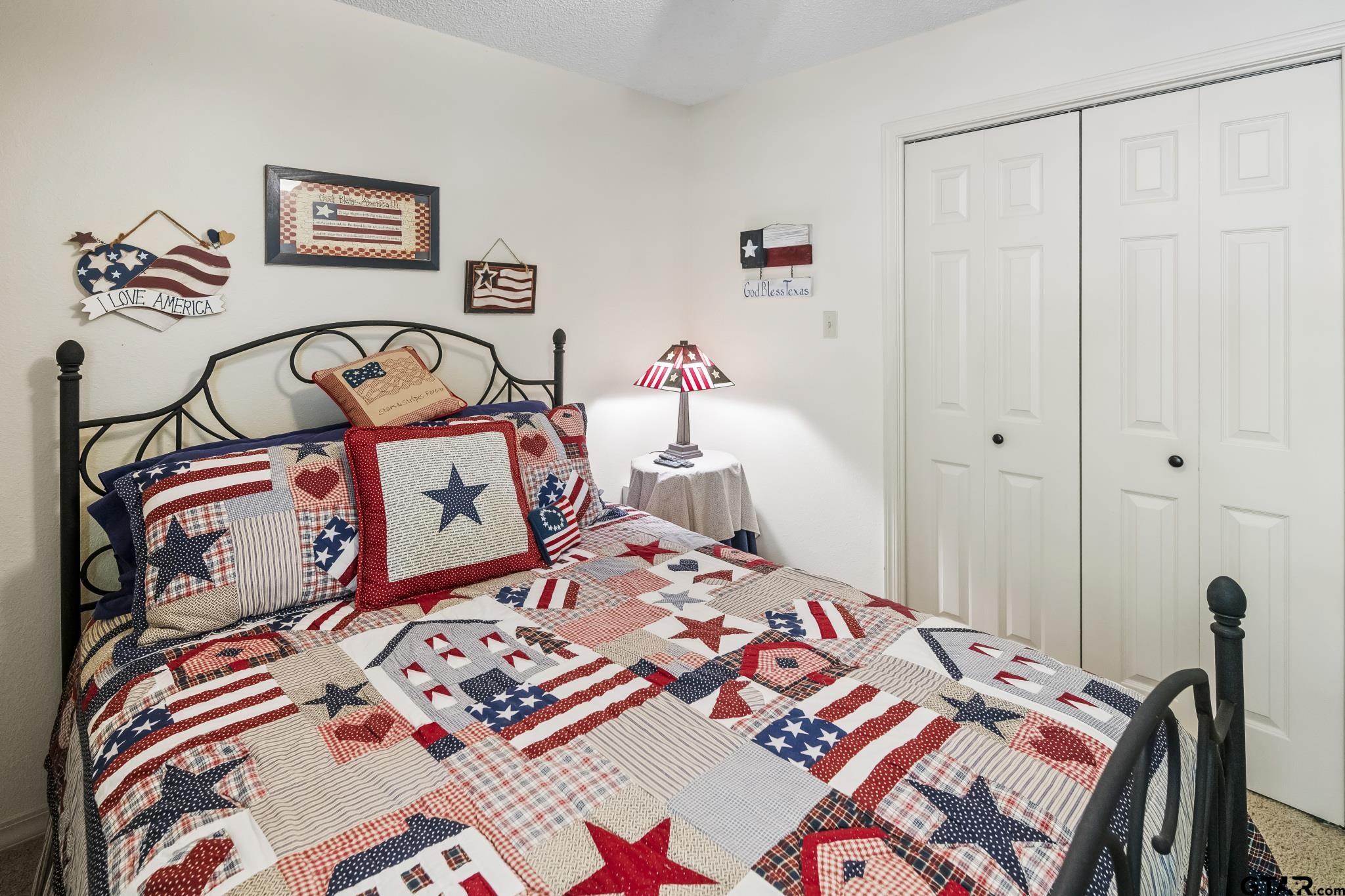 944 Clear Water Trail Holly Lake Ranch, TX 75765 - Photo 16 of 46 a bedroom with a bed and a table with rug