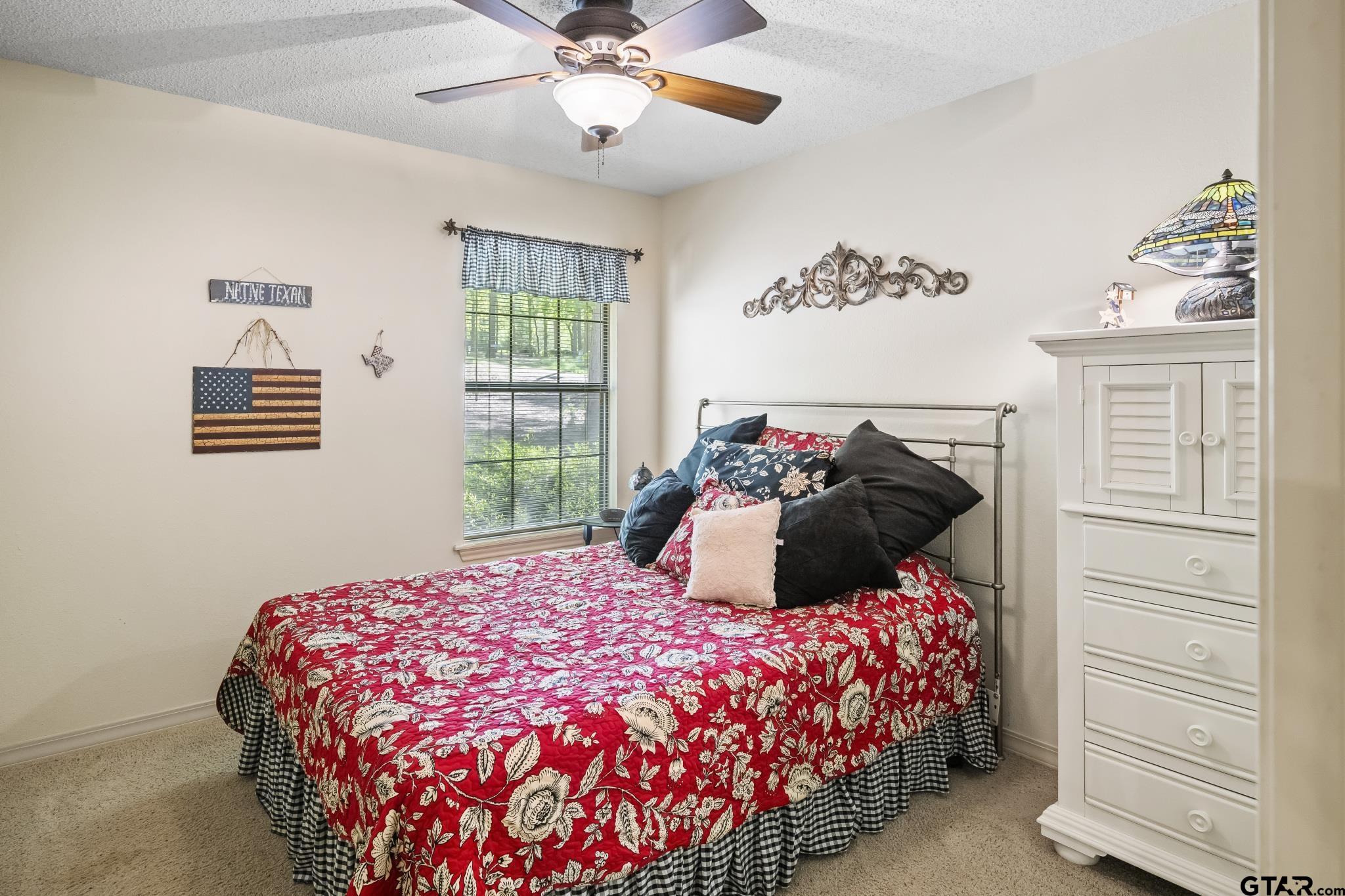 944 Clear Water Trail Holly Lake Ranch, TX 75765 - Photo 17 of 46 a bedroom with a large bed and a window