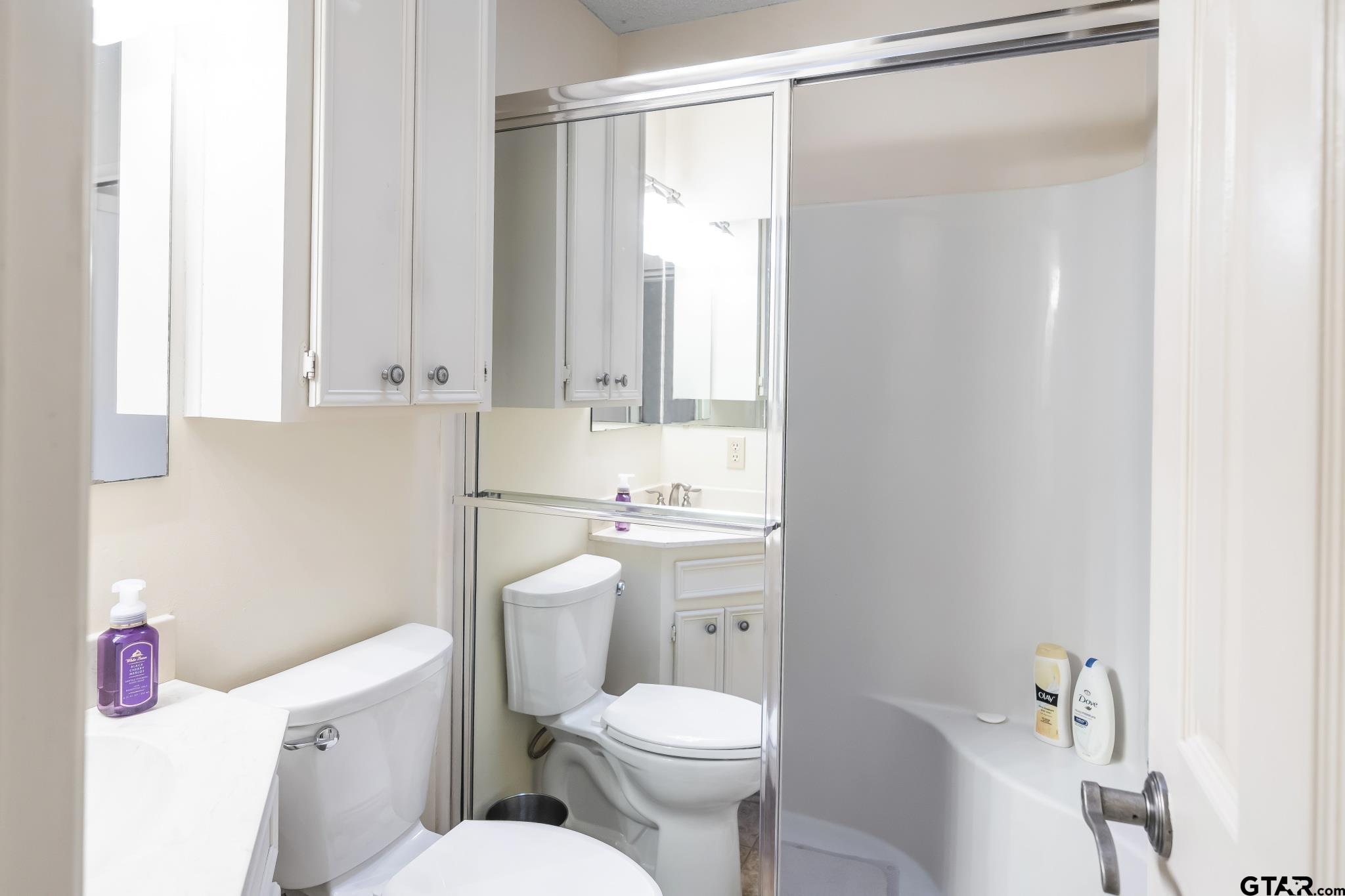 944 Clear Water Trail Holly Lake Ranch, TX 75765 - Photo 21 of 46 a white toilet sitting next to a bathroom sink