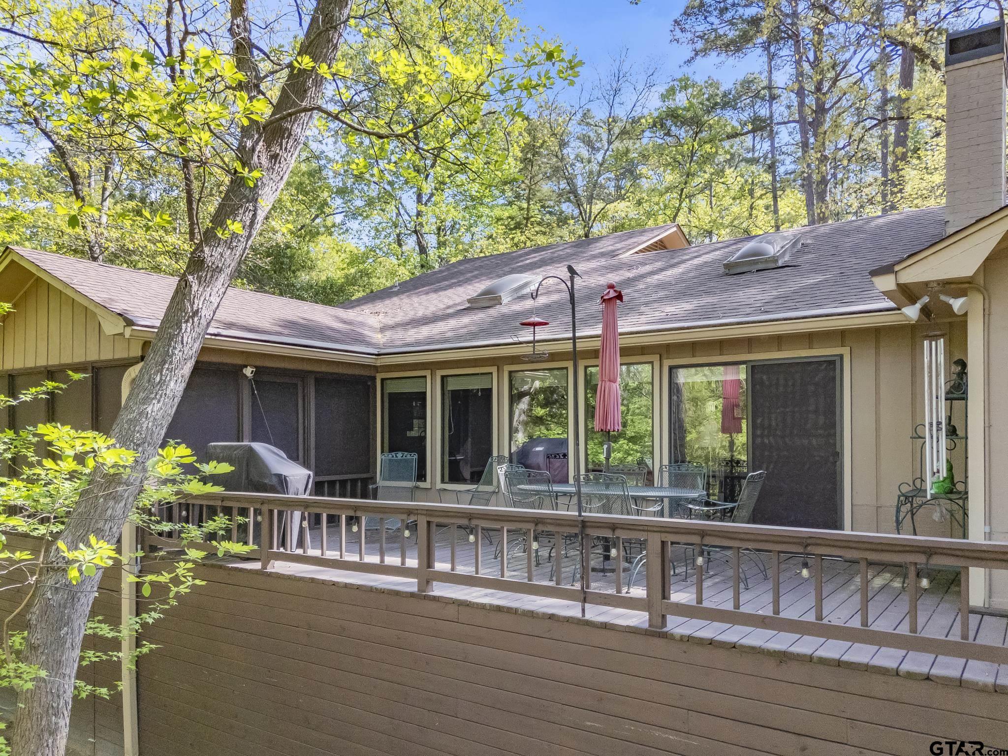 944 Clear Water Trail Holly Lake Ranch, TX 75765 - Photo 26 of 46 a view of a house with porch and garden
