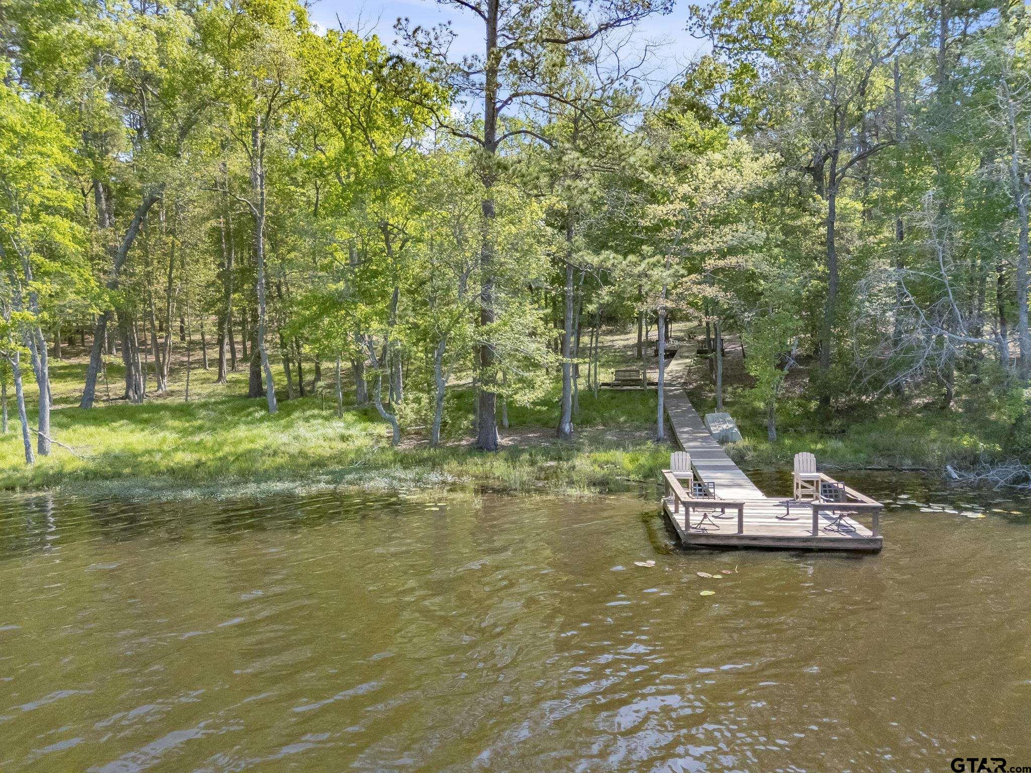 944 Clear Water Trail Holly Lake Ranch, TX 75765 - Photo 36 of 46 a view of a lake with a car parked