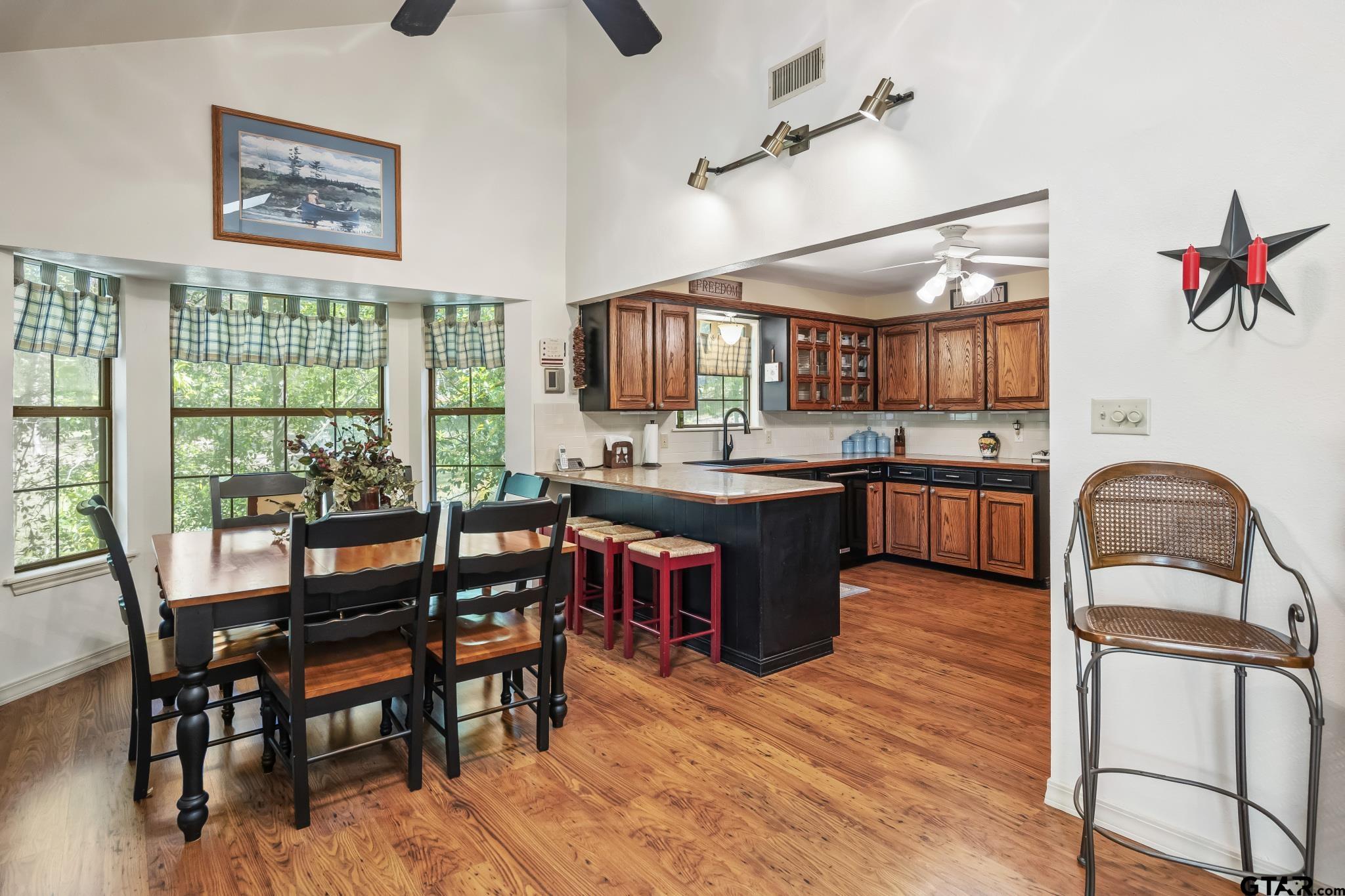 944 Clear Water Trail Holly Lake Ranch, TX 75765 - Photo 8 of 46 a kitchen with stainless steel appliances granite countertop a stove and a wooden floors