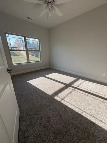 a room with wooden floor and white walls