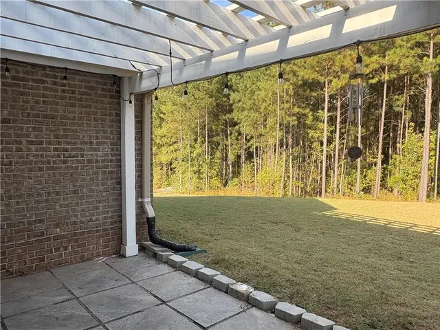 a view of a swimming pool with an outdoor space and seating area