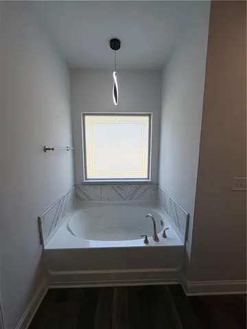 a bathroom with a bathtub and a window