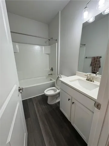 a bathroom with a double vanity sink toilet and shower