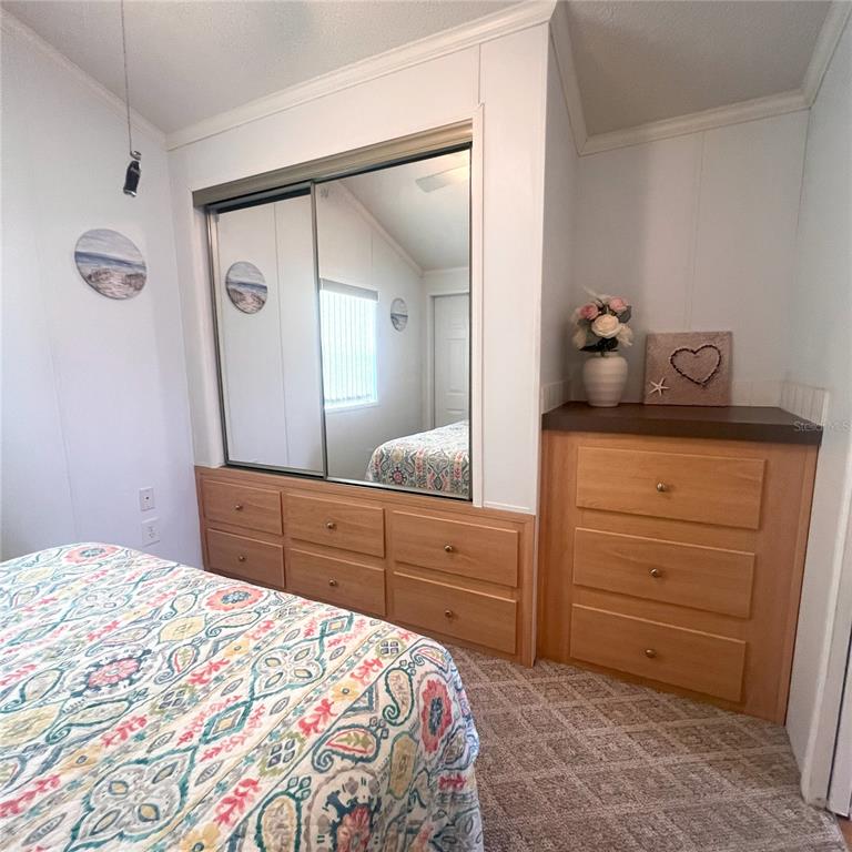 1202 Snook Punta Gorda, FL 33950 - Photo 12 of 33 a bedroom with a bed and a dresser