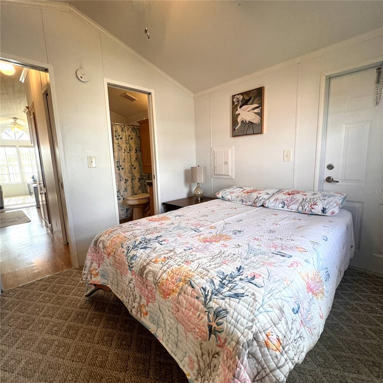 1202 Snook Punta Gorda, FL 33950 - Photo 13 of 34 a bedroom with a bed and a large mirror