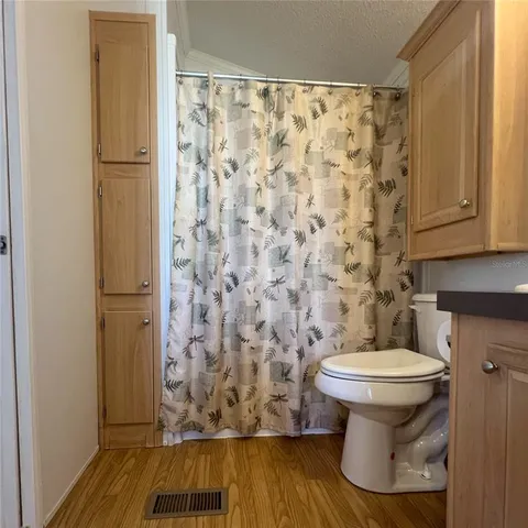 a bathroom with a toilet and a shower curtain