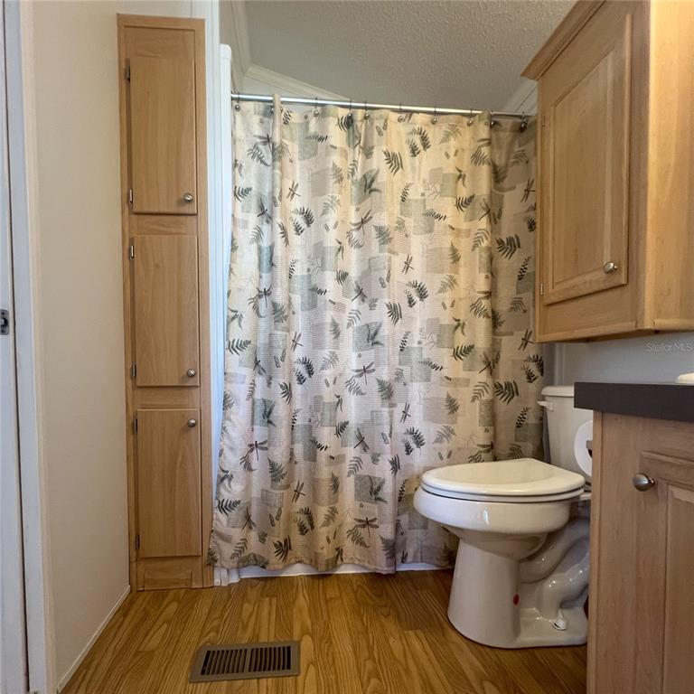 1202 Snook Punta Gorda, FL 33950 - Photo 15 of 33 a bathroom with a toilet and a shower curtain