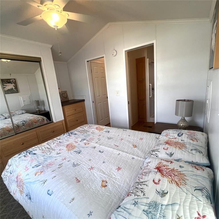 1202 Snook Punta Gorda, FL 33950 - Photo 15 of 34 a bedroom with a bed and a chandelier