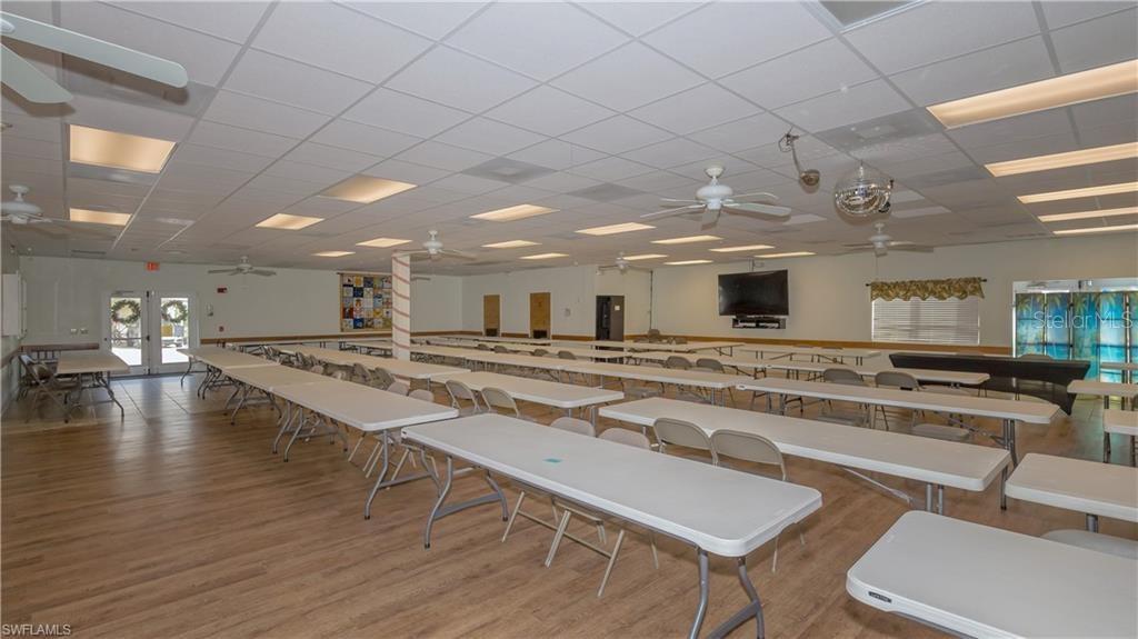 1202 Snook Punta Gorda, FL 33950 - Photo 29 of 33 a view of a kitchen with kitchen island a stove a table and chairs in it