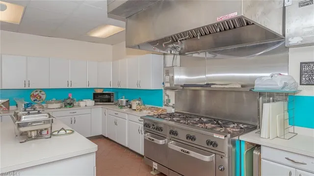 a kitchen with a stove and a white cabinets