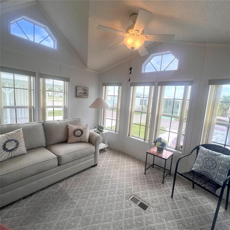 1202 Snook Punta Gorda, FL 33950 - Photo 3 of 34 a living room with furniture a chandelier and a large window