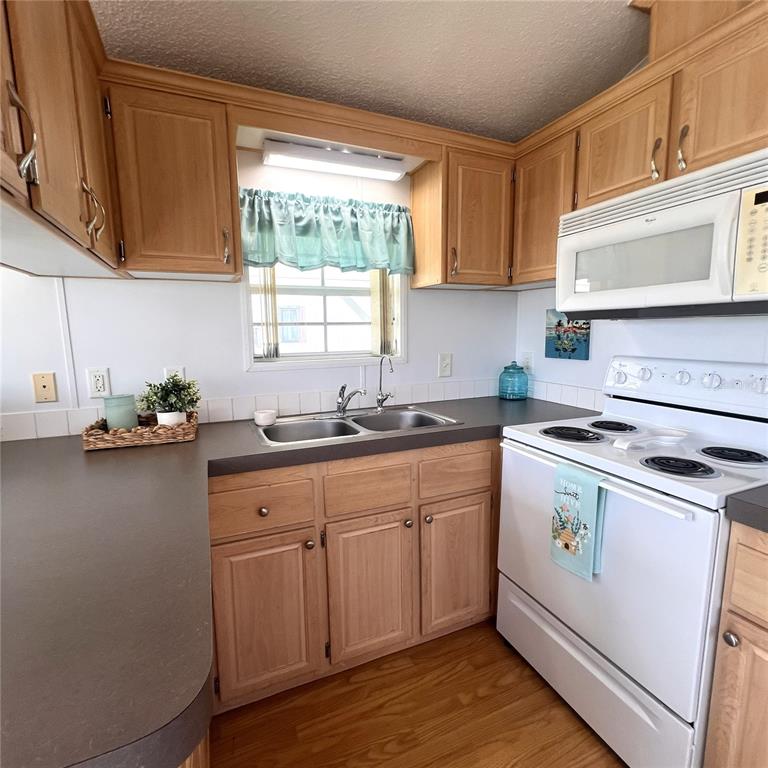 1202 Snook Punta Gorda, FL 33950 - Photo 10 of 34 a kitchen with a sink cabinets and wooden floor