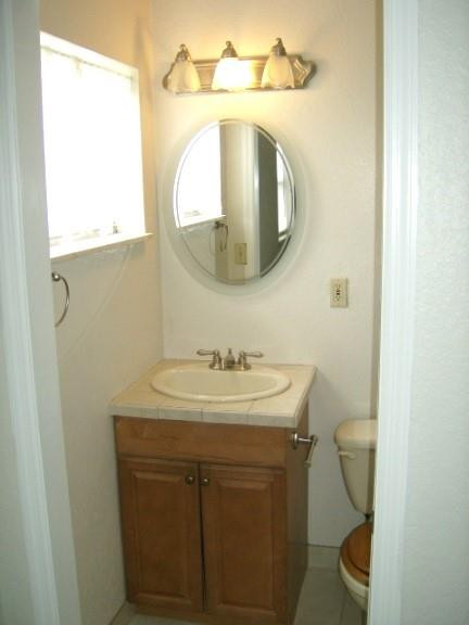 2301 Southwest 50th Terrace Plantation, FL 33317 - Photo 17 of 26 a bathroom with a toilet sink and mirror