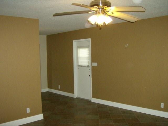 2301 Southwest 50th Terrace Plantation, FL 33317 - Photo 24 of 26 an empty room with a chandelier fan and a chandelier fan