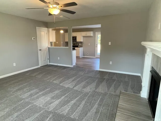 a view of a kitchen with a sink and a fireplace