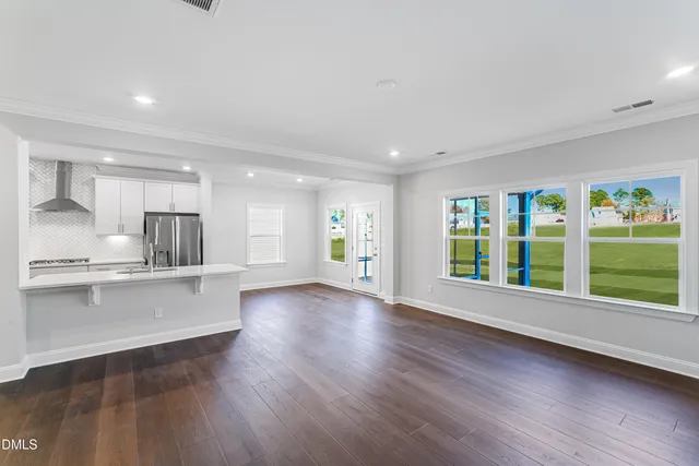 a kitchen with refrigerator cabinets and wooden floor