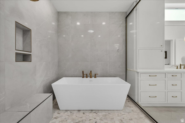 2608 Canyon Ridge Drive St. George, UT 84770 - Photo 38 of 86 Primary bathroom: freestanding soaking tub with brass fixtures, set against large format wall tiling and hexagonal floor tiling