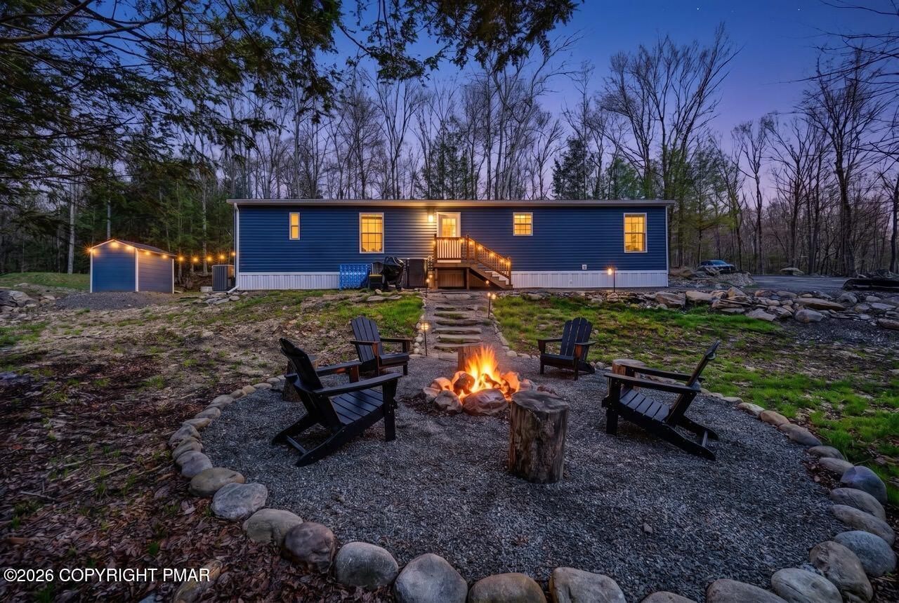 2194 Snow Hill Falls Road Cresco, PA 18326 - Photo 12 of 63 a view of a backyard with furniture and a fire pit