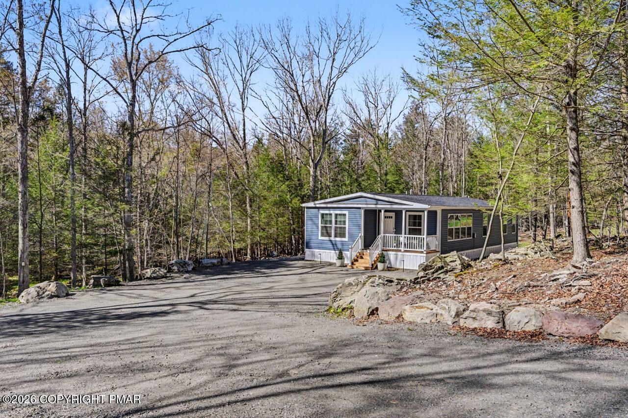 2194 Snow Hill Falls Road Cresco, PA 18326 - Photo 2 of 63 a front view of a house with yard