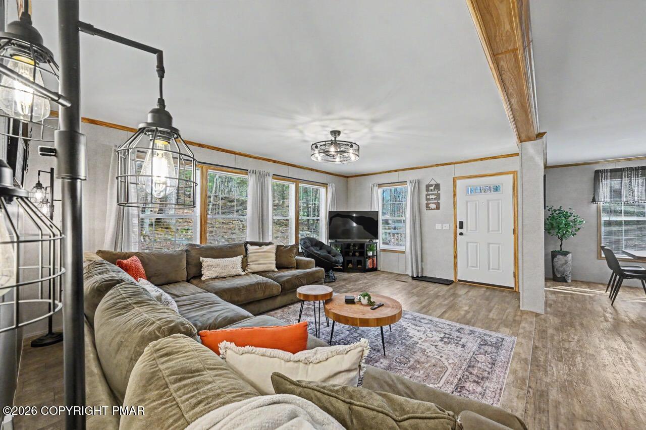 2194 Snow Hill Falls Road Cresco, PA 18326 - Photo 23 of 63 a living room with furniture and a chandelier