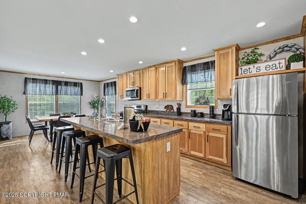 2194 Snow Hill Falls Road Cresco, PA 18326 - Photo 26 of 63 a kitchen with stainless steel appliances granite countertop a table chairs refrigerator and wooden cabinets