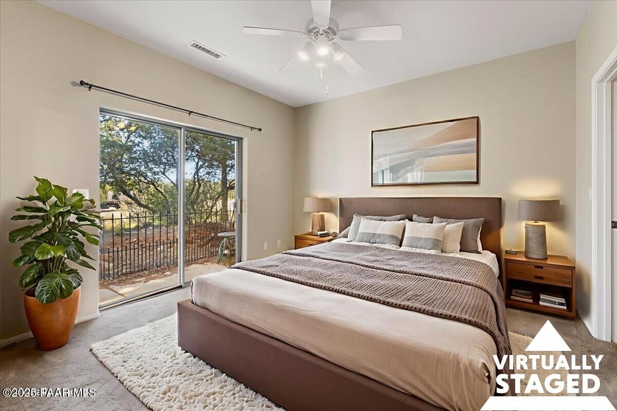 4976 Summit Circle Prescott, AZ 86301 - Photo 9 of 16 a bedroom with a large bed and a potted plant