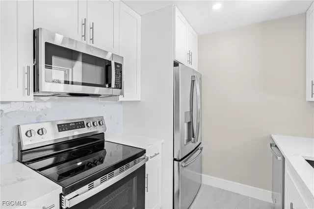 a kitchen with stainless steel appliances a stove microwave and sink