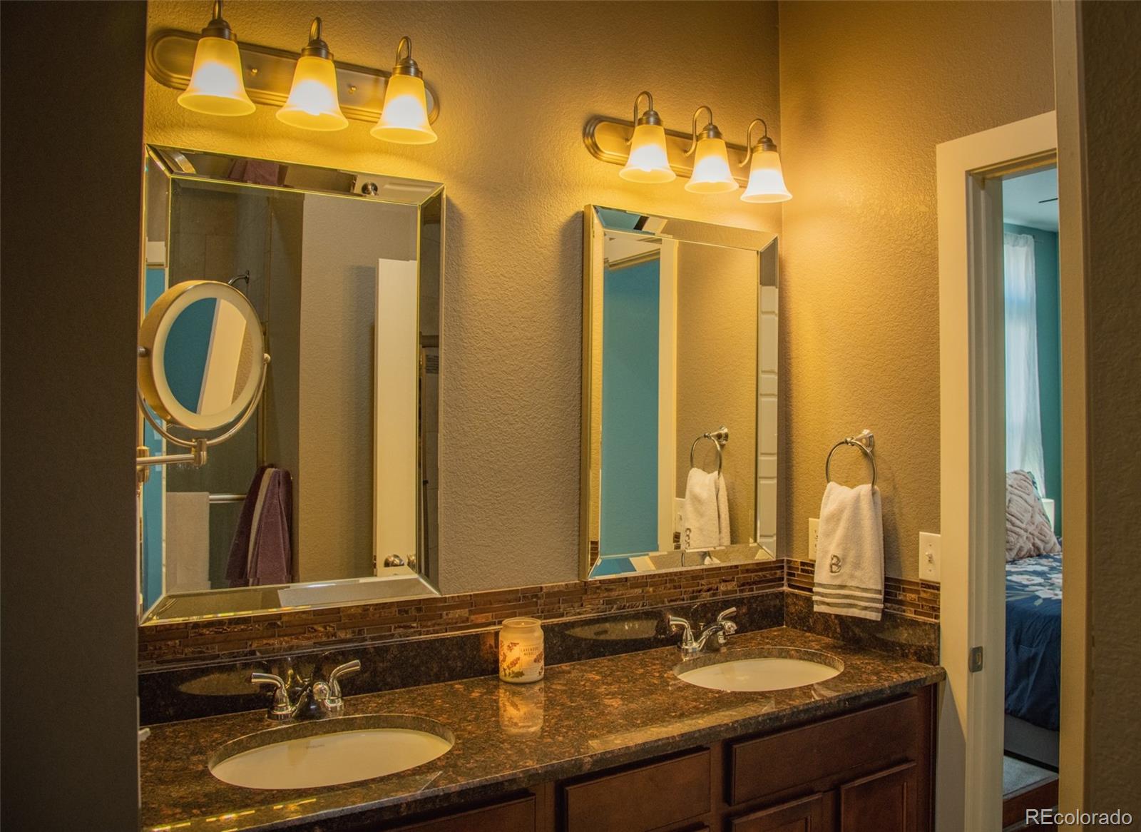 4428 Vindaloo Drive Castle Rock, CO 80109 - Photo 16 of 35 a bathroom with a double vanity sink and a mirror