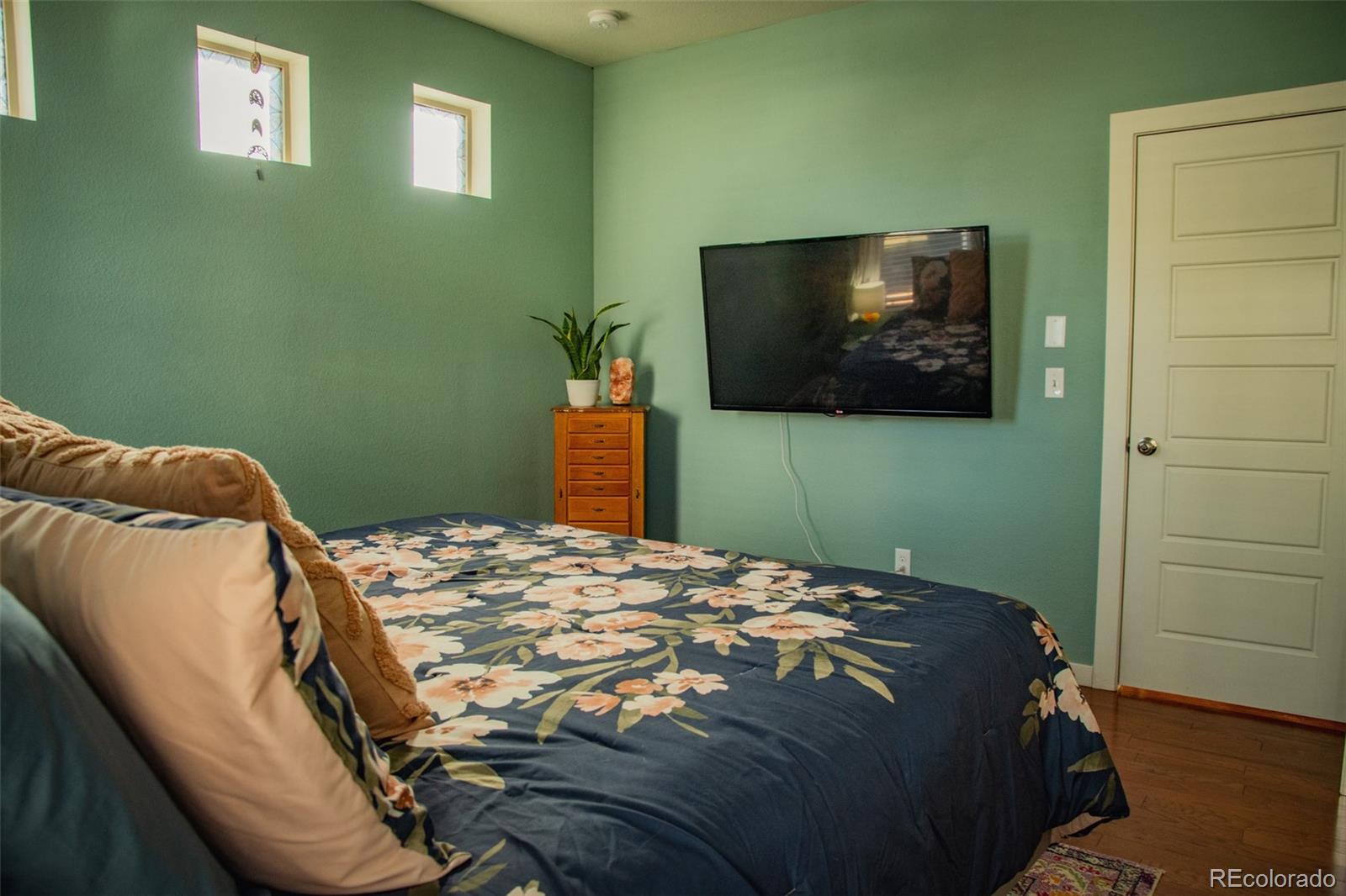 4428 Vindaloo Drive Castle Rock, CO 80109 - Photo 18 of 35 a bedroom with a bed and a flat screen tv