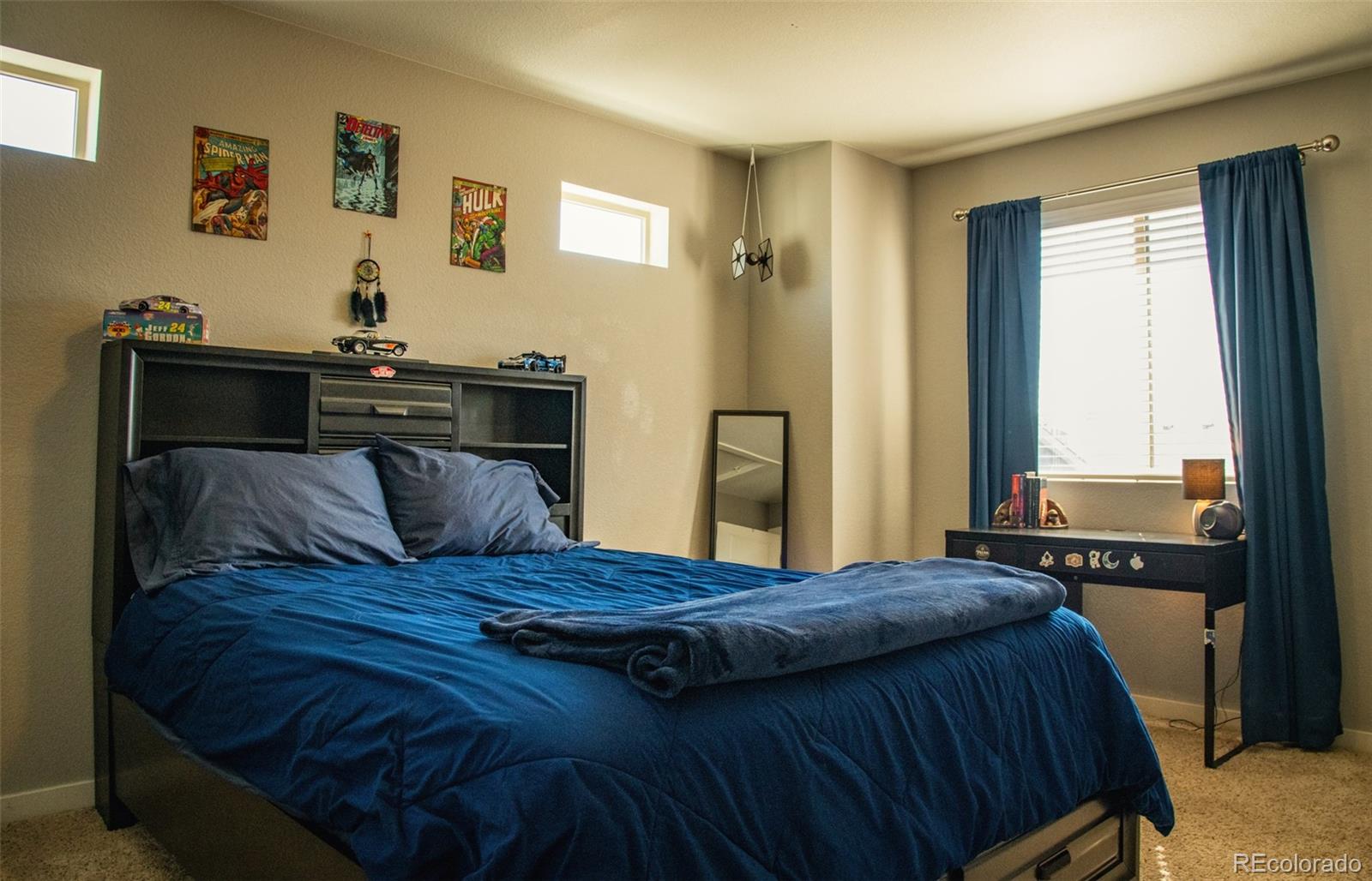 4428 Vindaloo Drive Castle Rock, CO 80109 - Photo 20 of 35 a bedroom with a bed and wooden floor
