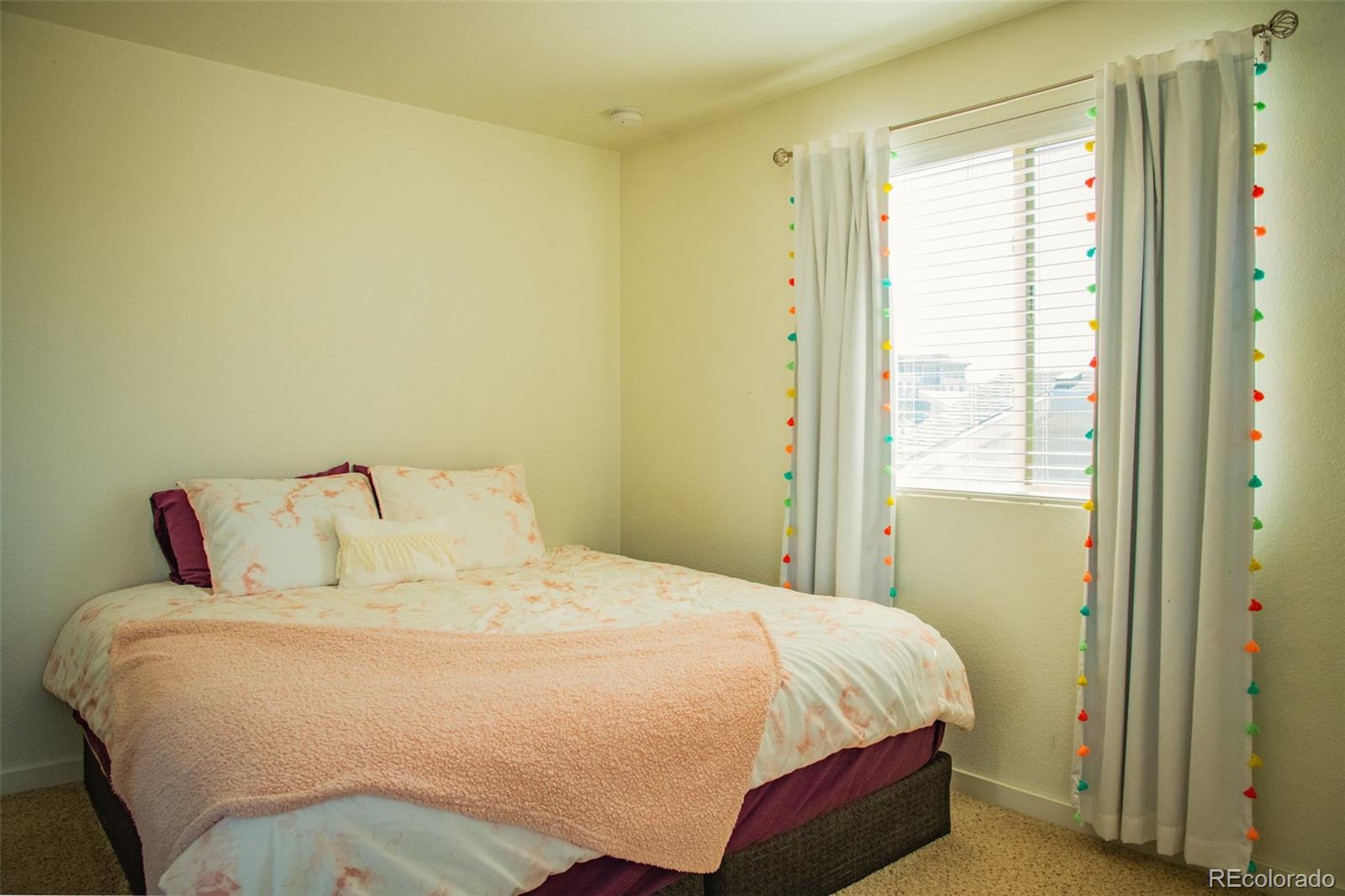 4428 Vindaloo Drive Castle Rock, CO 80109 - Photo 21 of 35 a large bed sitting in a bedroom next to a window