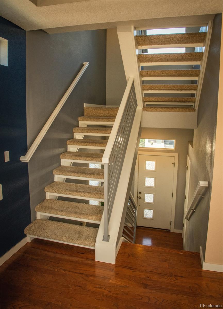 4428 Vindaloo Drive Castle Rock, CO 80109 - Photo 3 of 35 a view of entryway and hall with wooden floor