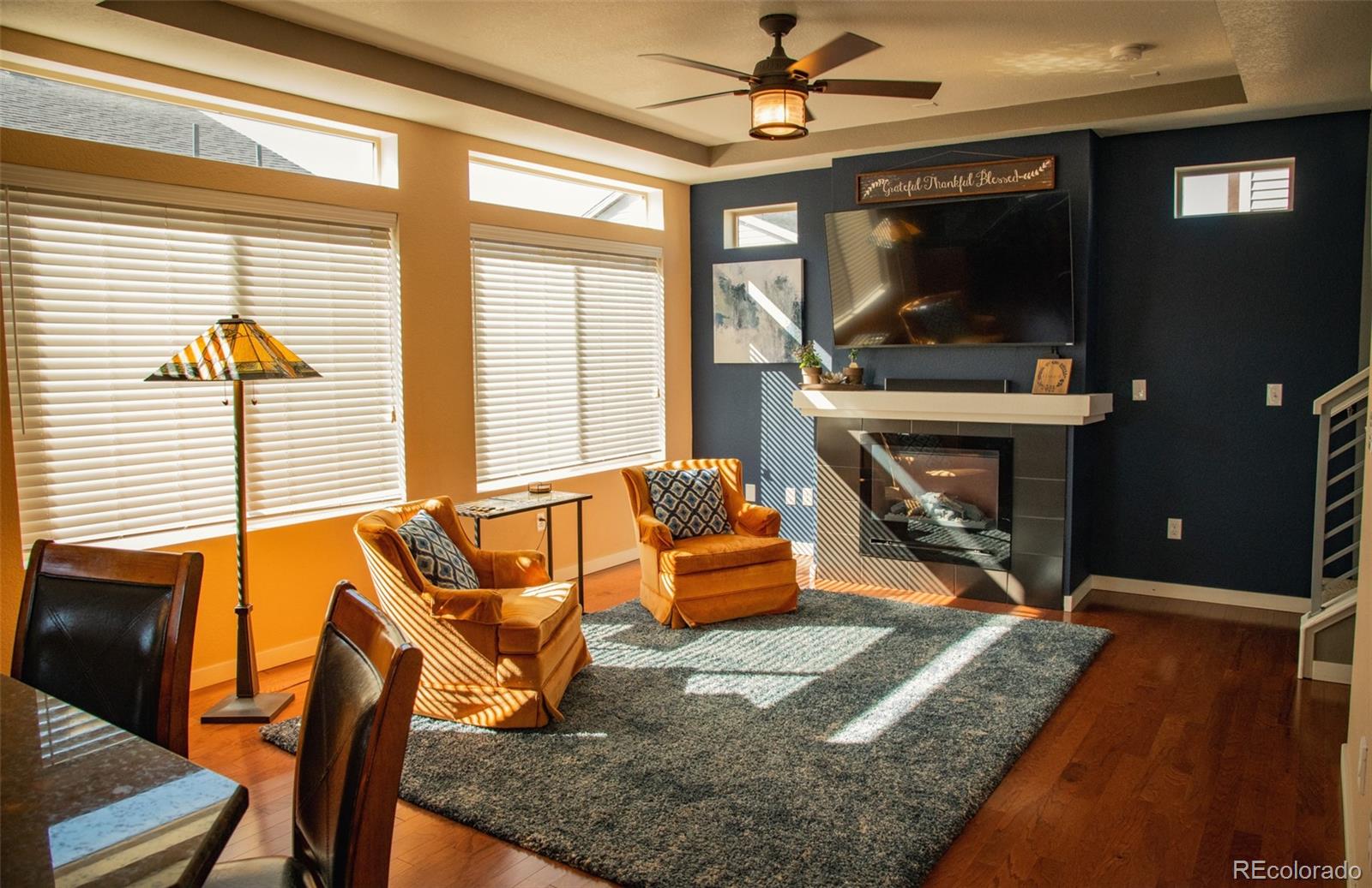 4428 Vindaloo Drive Castle Rock, CO 80109 - Photo 5 of 35 a living room with patio furniture and a fireplace