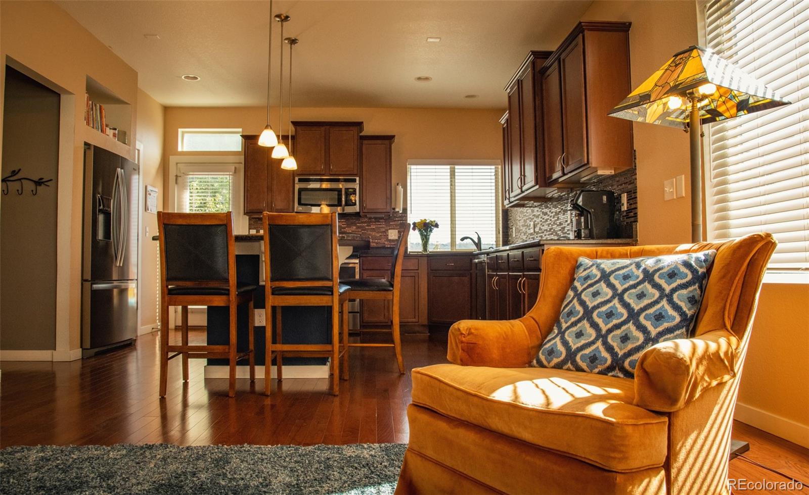 4428 Vindaloo Drive Castle Rock, CO 80109 - Photo 10 of 35 a view of a dining room with furniture window and wooden floor