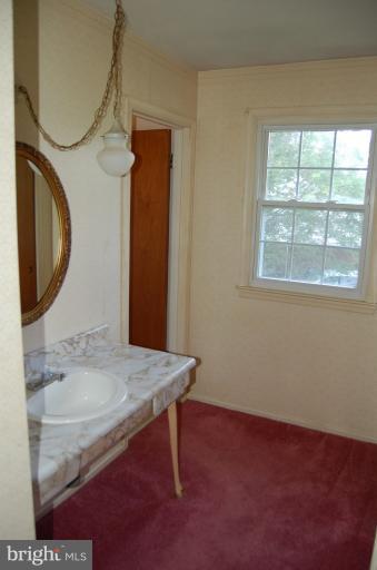 18916 Olney Mill Road Olney, MD 20832 - Photo 11 of 24 a bathroom with a sink a mirror and a toilet