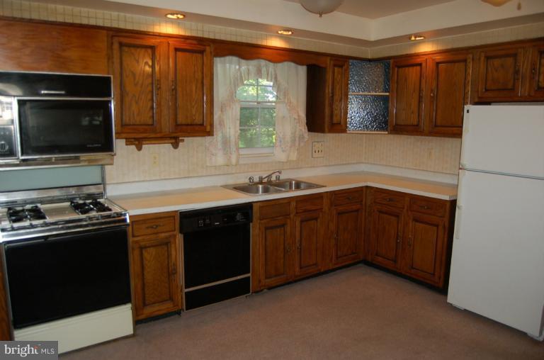 18916 Olney Mill Road Olney, MD 20832 - Photo 21 of 24 a kitchen with a sink stove and microwave